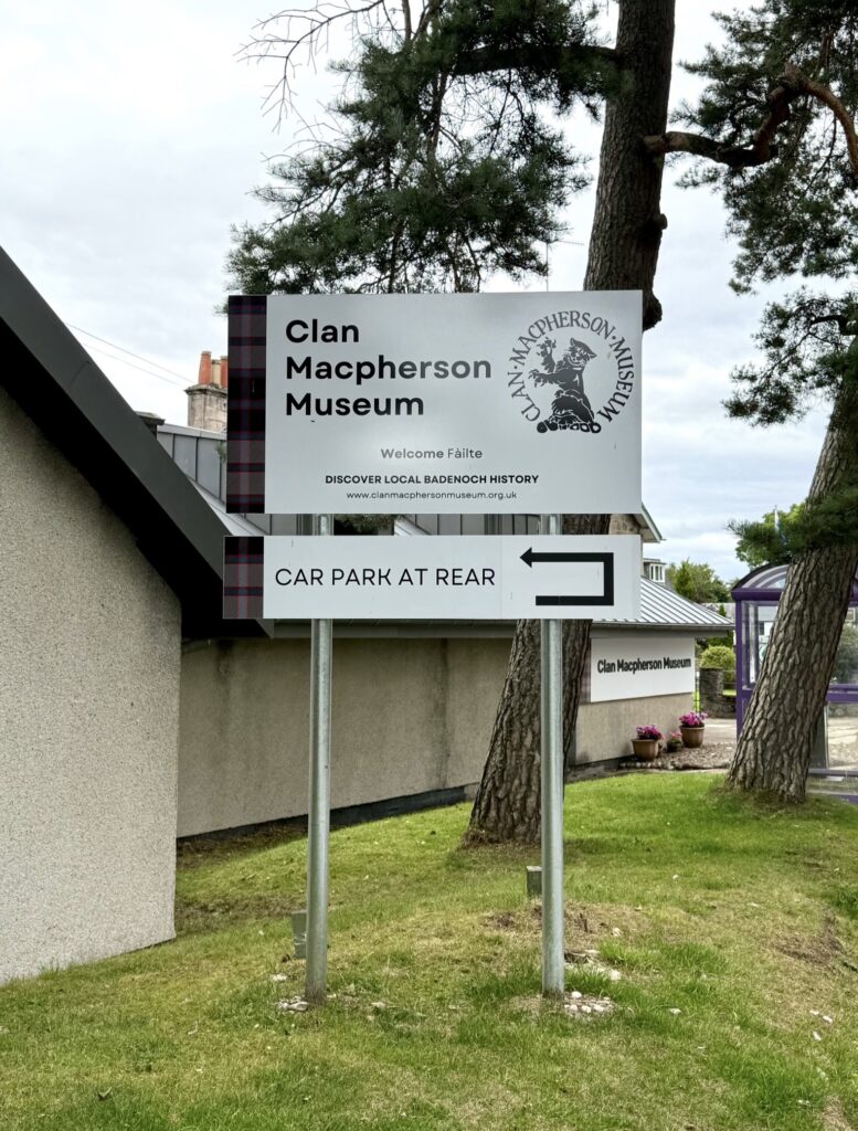 New exterior signage at the Clan Macpherson Museum, Perth Road side, with welcome and car park directions.